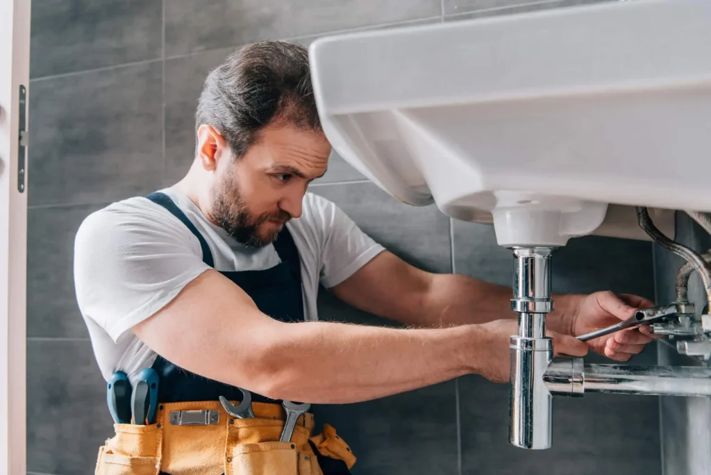 focused male plumber in working